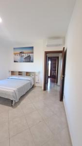 a bedroom with a bed and a tile floor at Bed and Bike in Vasto