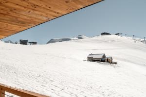 a house on top of a snow covered hill at Le Refuge Chez La Tante - Mont d'Arbois, accès en télécabine avant 16h30 in Saint-Gervais-les-Bains