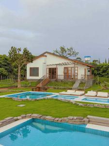 an aerial view of a house with two swimming pools at Villa Đăng HảI in Buôn Du Enguôl