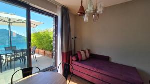 a living room with a couch and a large window at La Giulia Suites like Home in Bonassola