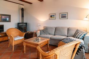 a living room with a couch and chairs and a table at Ferienwohnung "Wildgans" in Schaprode