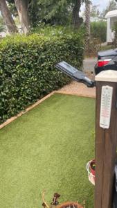 a baseball bat sitting on top of a yard at Mobilhome 6 personnes in Hyères +9 photos