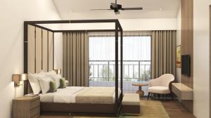 a bedroom with a canopy bed and a window at The Astor - All Suites Hotel Candolim Goa in Candolim