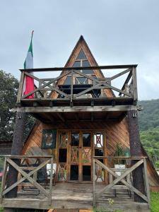 a wooden house with a gambrel roof at Oasis Hotel & Resort Mazamitla in Caliguana