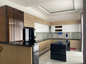 a kitchen with a black and white counter top at The Palm Phu Quoc Resort & Villa in Phú Quốc