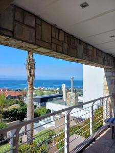 a view of the ocean from the balcony of a house at Eagle's Nest in Mossel Bay