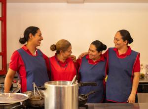 a group of women standing in a kitchen at Hacienda Venecia Coffee Farm Hotel in Manizales +107 photos