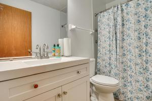 a bathroom with a sink and a toilet and a shower at 12 Mi to Dtwn St Paul Extended Stay in Woodbury! in Woodbury