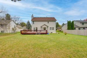 a white house with a red fence in a yard at 12 Mi to Dtwn St Paul Extended Stay in Woodbury! in Woodbury