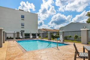 a swimming pool in front of a building at Candlewood Victoria by IHG in Victoria