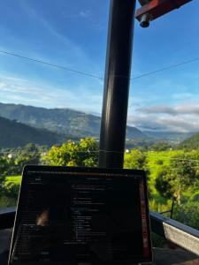 a laptop computer sitting in front of a window at Stay with Nature in Kusma