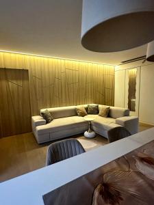 a living room with a couch and a table at Stilingas dviejų kambarių butas in Vilnius