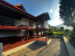 a house with a balcony and a deck with a view at Stay with Nature in Kusma