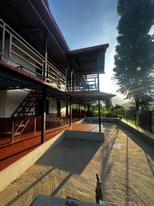 a large building with a staircase on top of it at Stay with Nature in Kusma