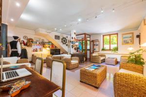 a man standing in a room with a laptop on a table at Domus De Janas Sul Mare in Bari Sardo