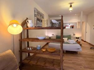 a room with a bunk bed and a room with a lamp at LEscala - Ventalló. Cosy WiFi Rooftop terrace in Ventalló +188 photos