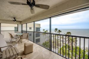 a balcony with a table and chairs and the ocean at Sand Pointe 137 in Sanibel