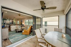a balcony with a table and chairs and a living room at Sand Pointe 137 in Sanibel