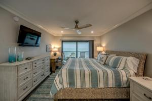 a bedroom with a bed and a dresser at Sand Pointe 137 in Sanibel