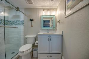 a bathroom with a toilet and a sink and a shower at Sand Pointe 137 in Sanibel +47 photos