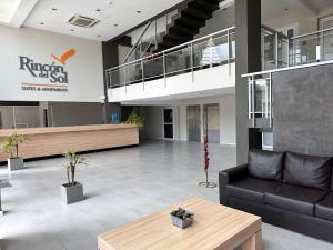 a lobby of a building with a couch and a table at Suite del Sol 106 in Pinamar +11 photos