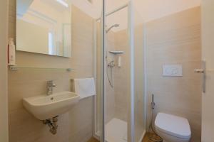 a bathroom with a toilet and a sink and a shower at Camera Helsinki - La Casa di Carta Affittacamere in Udine +1 photo