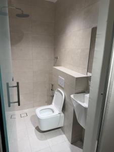 a bathroom with a toilet and a sink at ستاي إن Stay Inn in Ma‘mad +11 photos