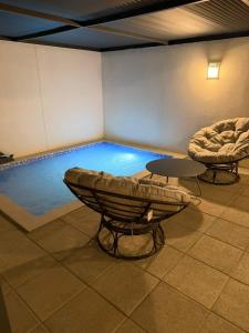 a swimming pool in a room with a table at ستاي إن Stay Inn in Nizwa