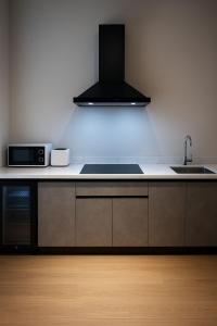 a kitchen with a sink and a microwave at ستاي إن Stay Inn in Nizwa