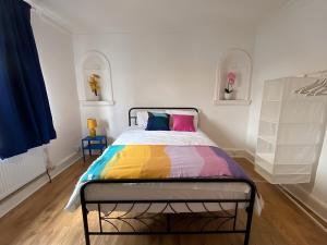 a bedroom with a bed with a colorful blanket at 4-Bedrooms - Perfect for those working in Bridgend in Bridgend