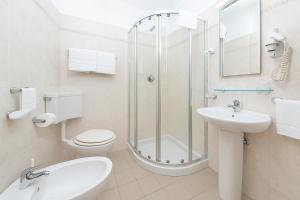 a bathroom with a shower and a toilet and a sink at Hotiday La Spezia Centrale in La Spezia