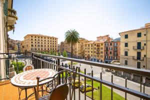 a balcony with a table and chairs and buildings at Hotiday La Spezia Centrale in La Spezia