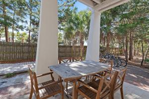 a wooden table and chairs on a porch at Inlet Beach - 70 Pinecrest in Panama City Beach