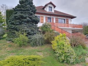 a house with a large tree in front of it at Le Gite de Pigneux in Truison