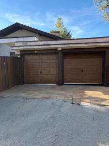a pair of garage doors on a house at Villa appartment in Vinohrady