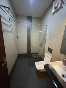 a bathroom with a shower and a toilet and a sink at Casa goa in Calangute