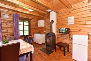 SkirlėnaiLAKE VIEW Resort - Sodyba的带桌子和木炉的餐厅