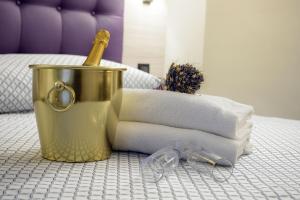 
a bucket of soap next to a pillow on a bed at Hotel Torino Porta Susa in Turin
