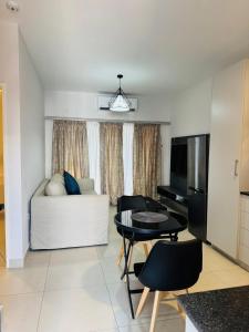 a living room with a couch and a table at Kastina Suites at The Fig in Gaborone