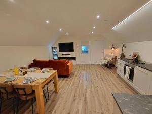 a living room with a couch and a table at Macaldrack's Loft in Dunloy