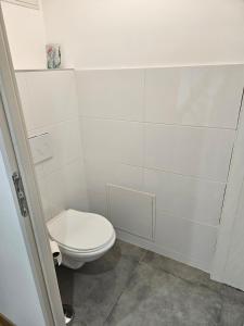 a small white bathroom with a toilet in it at Un duplex lumineux in Mer