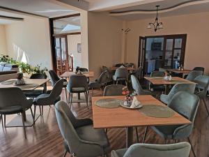 a restaurant with tables and chairs in a room at Villa Prestige in Sovata