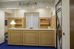 a room with a reception counter with flowers on it at Hotel Torino Porta Susa in Turin