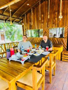two people sitting at a table in a restaurant at Residence Inn in Udawalawe