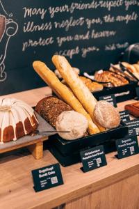 a display of bread and pastries on a counter at pentahotel Kassel in Kassel