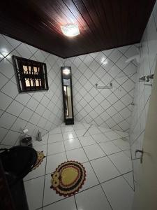 a tiled bathroom with a shower and a toilet at Sítio Vô Leno in Biguaçu +15 photos