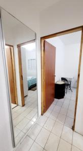a hallway with a mirror and a room at Casa Aeroporto a poucos minutos do Aeroporto de Viracopos in Campinas +4 photos