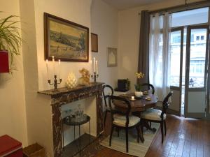 a living room with a fireplace and a table and chairs at Villa Seven 2 in Dunkerque