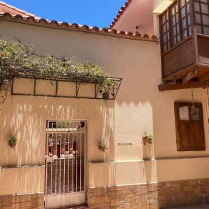 a building with a gate with plants on it at B&B SANTA CECILIA in Sucre