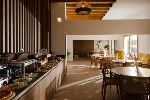 a restaurant with a buffet line with plates of food at Portiani Suites in Adamantas